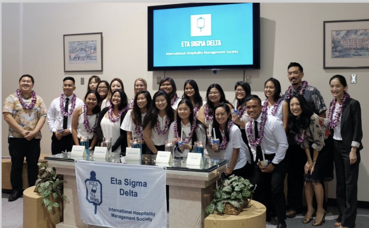 The UH Manoa School of Travel Industry Management honor society Eta Sigma Delta receives Chapter of Distinction Award.